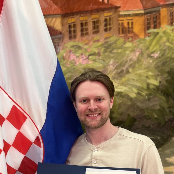 Salona Consulting client Andrew next to the Croatian flag.