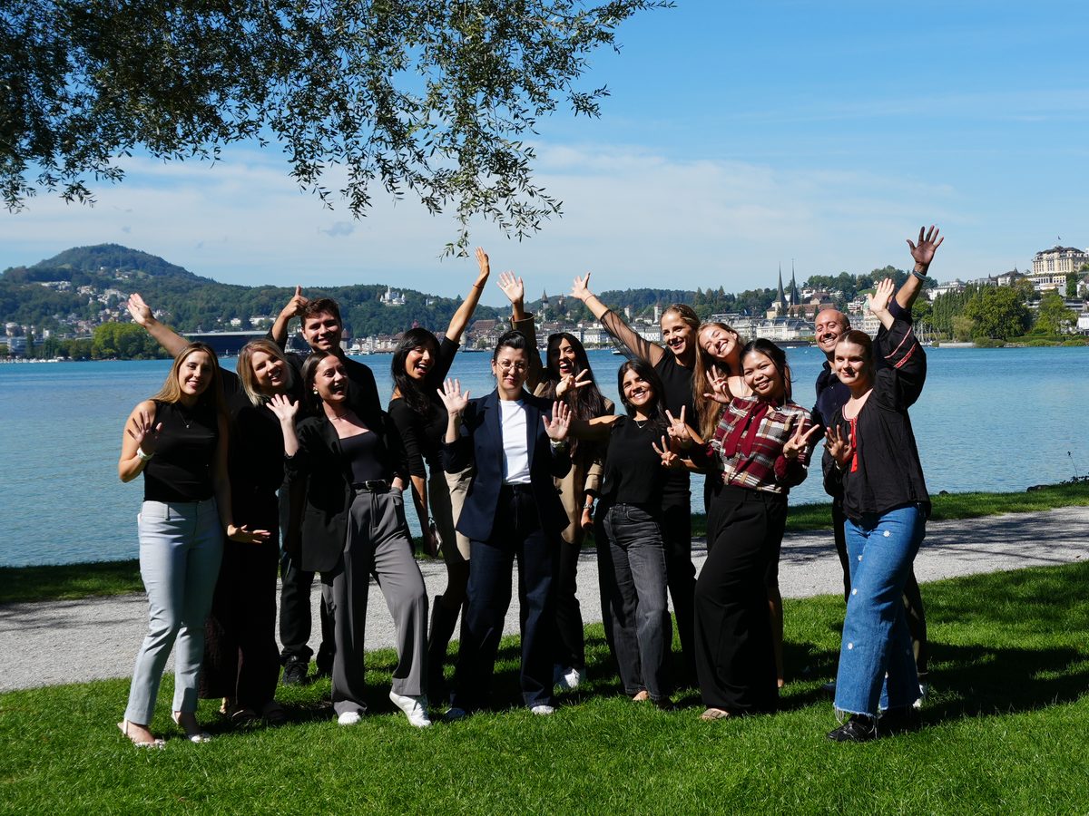 The Salona Consulting team by Lake Lucerne, the city behind them